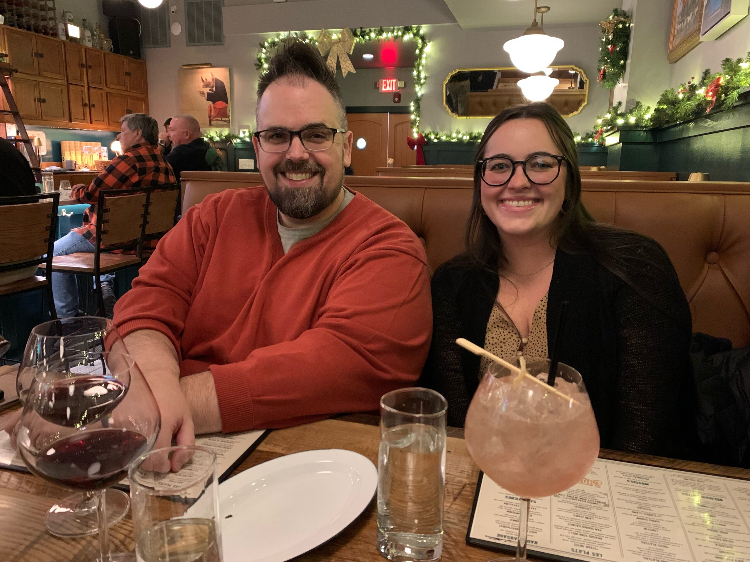 one guy and one girl sitting in restaurant booth