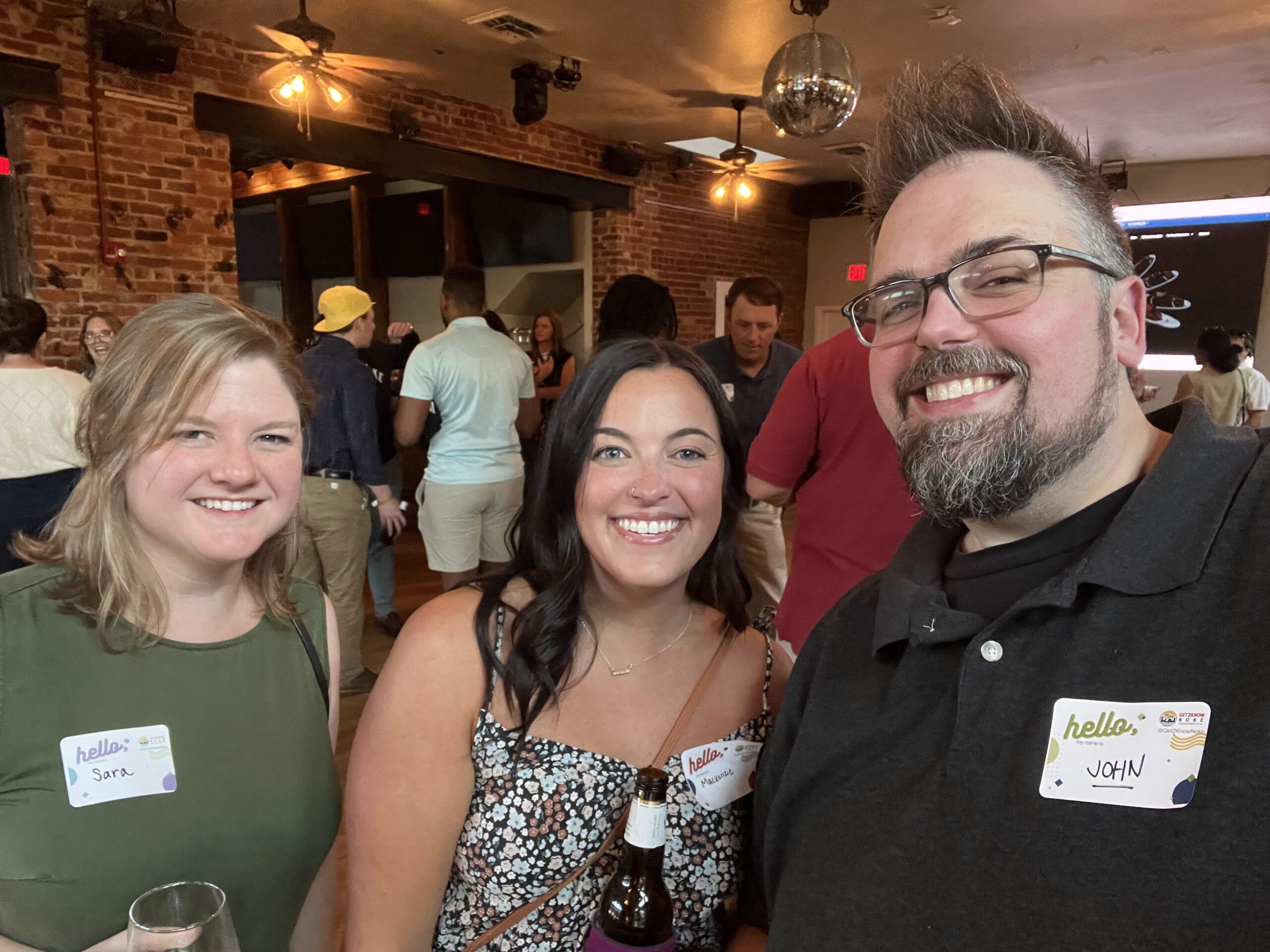two girls and one guy smiling