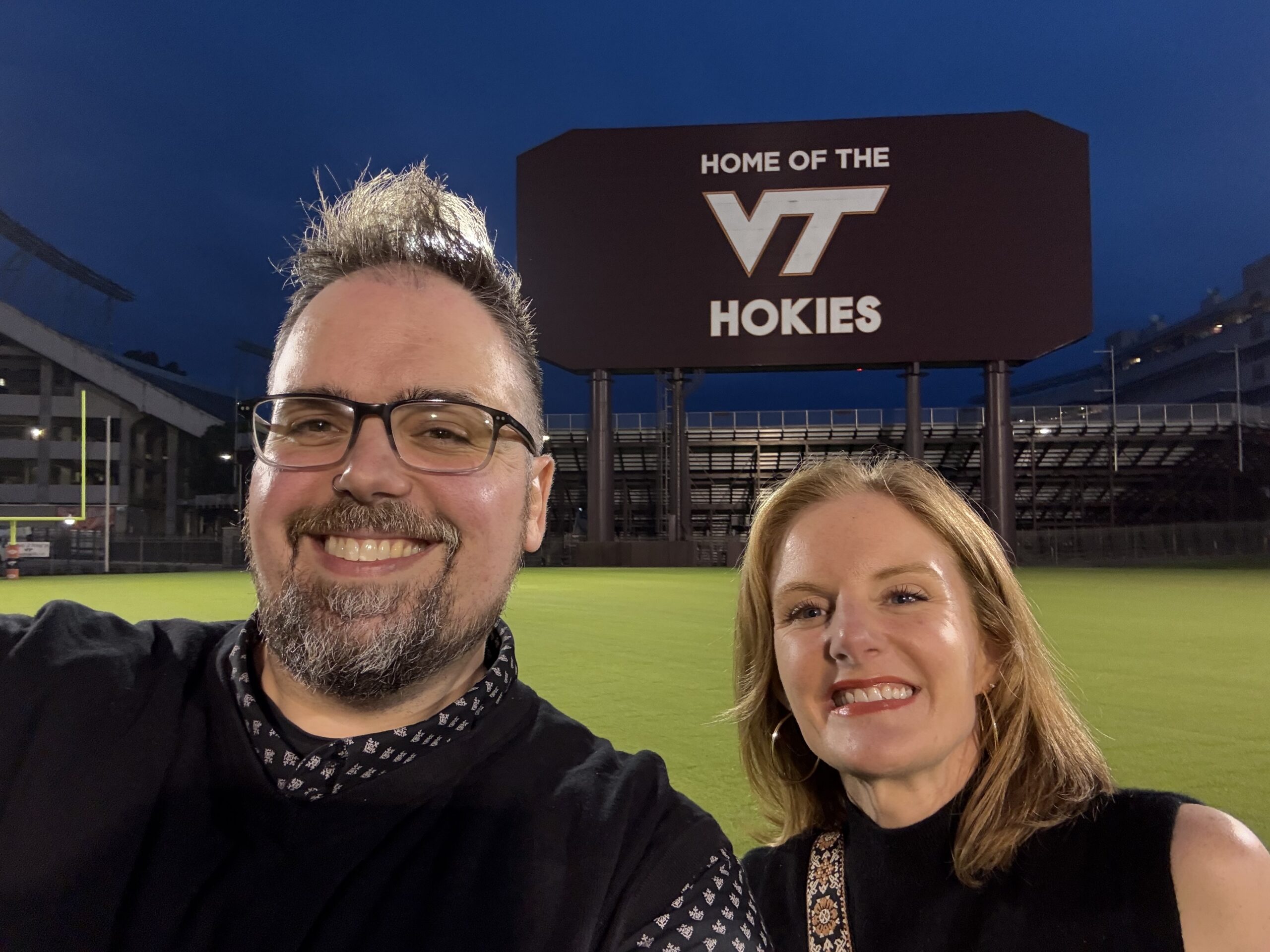 one girl and one guy in front of sign
