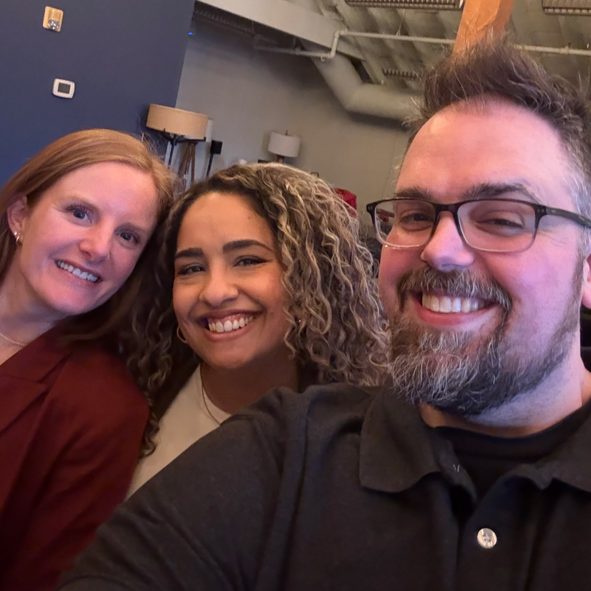 two girls and one guy smiling